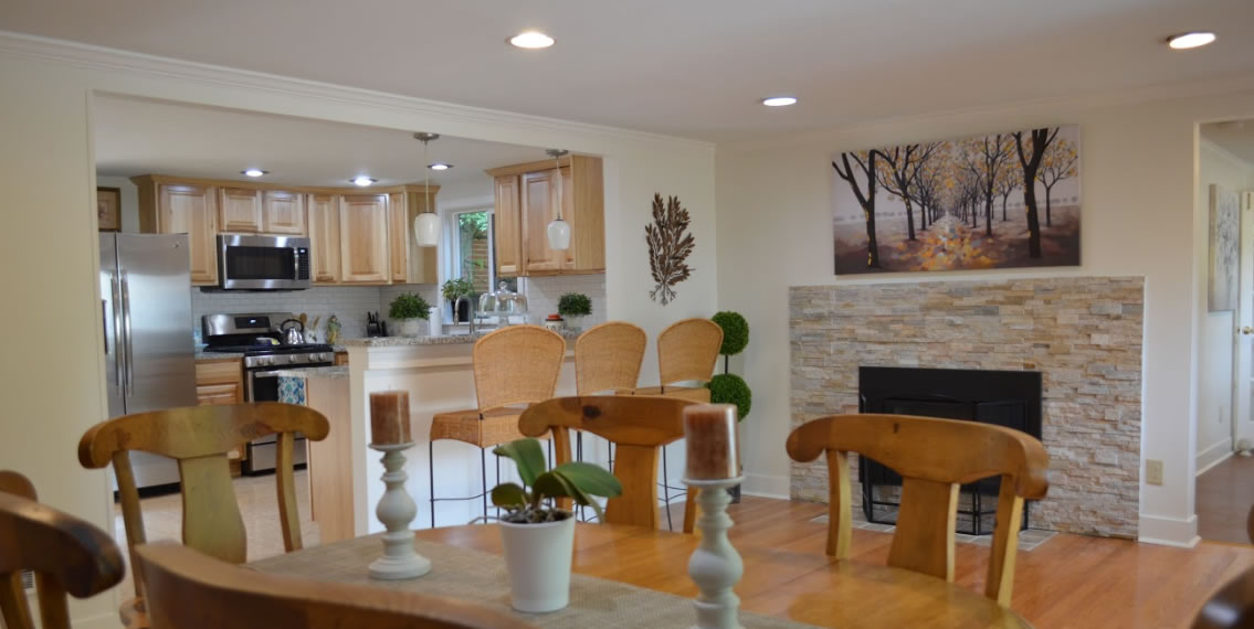 Dining room area with kitchen in the background.