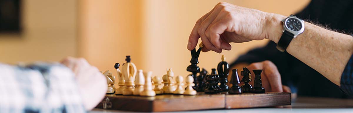 Two elderly gentlemen playing a game of chess.