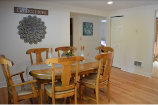 Dining room with oak table and six chairs.