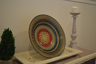 Designer plate on side table in the corridor leading from living room to dining room.